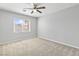 Bright bedroom with neutral walls, plush carpet, and a ceiling fan at 1063 Silver Star St, Henderson, NV 89002