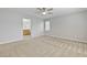 Large carpeted bedroom with a ceiling fan and ensuite bathroom at 1063 Silver Star St, Henderson, NV 89002