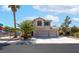 Charming two-story home featuring a three-car garage, desert landscaping, and a welcoming facade at 1063 Silver Star St, Henderson, NV 89002
