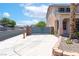 Beautiful home featuring mature palm trees and desert landscaping. A security gate provides extra privacy at 1063 Silver Star St, Henderson, NV 89002