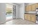 Bright kitchen with stainless appliances, breakfast bar, and sliding glass door to pool at 1063 Silver Star St, Henderson, NV 89002