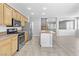 Open concept kitchen features stainless appliances and breakfast bar with a view at 1063 Silver Star St, Henderson, NV 89002