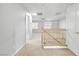 Loft area featuring a wooden banister, open doorways, and carpeted floors, providing a versatile space at 1063 Silver Star St, Henderson, NV 89002