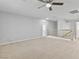Loft space featuring a ceiling fan, carpet, neutral walls, and a wooden banister offers a versatile area at 1063 Silver Star St, Henderson, NV 89002