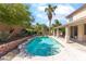 Beautiful pool with brick border, mature landscaping, and covered patio for relaxation at 1063 Silver Star St, Henderson, NV 89002