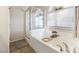 Bright bathroom with a separate shower and soaking tub under a window at 10638 La Spezia Way, Las Vegas, NV 89141