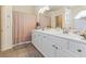 Bright bathroom features a dual sink vanity with white cabinets and a separate shower and bath at 10638 La Spezia Way, Las Vegas, NV 89141