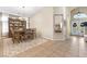 A spacious dining room with a dining table, china cabinet, and decorative rug near the front door at 10638 La Spezia Way, Las Vegas, NV 89141