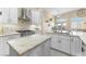 Bright kitchen features white cabinetry, stainless steel appliances, and stone countertops with island at 10638 La Spezia Way, Las Vegas, NV 89141