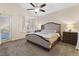 Cozy main bedroom with a window seat, neutral tones, and access to an outdoor area at 10638 La Spezia Way, Las Vegas, NV 89141