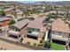 Aerial view showcasing a row of houses with backyards, patios, and desert landscaping at 1165 Cactus Rock St, Henderson, NV 89011