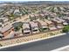 Aerial view of a neighborhood featuring multiple homes with desert landscaping and paved streets at 1165 Cactus Rock St, Henderson, NV 89011
