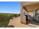 Cozy backyard featuring a covered patio with brick flooring and lush, trimmed greenery at 1165 Cactus Rock St, Henderson, NV 89011