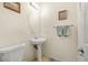 Clean and simple half bathroom featuring a pedestal sink, tiled floor, and neutral decor at 1165 Cactus Rock St, Henderson, NV 89011