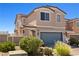 Inviting two-story home with a well-maintained front yard and attached two-car garage at 1165 Cactus Rock St, Henderson, NV 89011