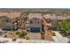 Residential house featuring a two-car garage, paved driveway, and landscaped front yard at 1165 Cactus Rock St, Henderson, NV 89011