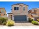 Front exterior of a home featuring desert landscaping, a two-car garage, and covered entryway at 1165 Cactus Rock St, Henderson, NV 89011