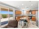 Bright kitchen featuring an island with seating, stainless appliances, and outdoor views at 1165 Cactus Rock St, Henderson, NV 89011