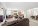 Spacious living room featuring plush furniture, neutral decor, and an open layout leading to the kitchen and dining area at 1165 Cactus Rock St, Henderson, NV 89011