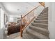 Carpeted staircase with wood banister leading to an open living area at 1165 Cactus Rock St, Henderson, NV 89011