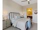 Bedroom featuring a ceiling fan, neutral walls and carpet, and lamps on the nightstands at 120 Los Cabos Dr # 301, Las Vegas, NV 89144