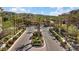 Elegant gated community entrance with lush landscaping, mature palm trees and manicured grounds at 120 Los Cabos Dr # 301, Las Vegas, NV 89144