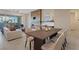 An open-concept living room and dining area shows the fireplace and sliding door access to outside at 120 Los Cabos Dr # 301, Las Vegas, NV 89144