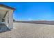 View of a spacious backyard with pavers and gravel at 1525 Heights Dr, Logandale, NV 89021