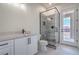 Well lit bathroom with a stand-up shower, modern vanity, and glass door to backyard at 1525 Heights Dr, Logandale, NV 89021