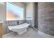 A contemporary bathroom showcasing a modern soaking tub and a separate shower with stylish tile work at 1525 Heights Dr, Logandale, NV 89021