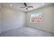 The spacious bedroom with a ceiling fan, tile floor, and natural light from the backyard window at 1525 Heights Dr, Logandale, NV 89021