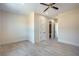 A neutral bedroom features tile floors, a ceiling fan, white trim, and multiple doors at 1525 Heights Dr, Logandale, NV 89021