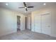 A spacious bedroom with a ceiling fan, tile floor, and walk-in closet at 1525 Heights Dr, Logandale, NV 89021
