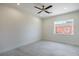 A spacious bedroom with a ceiling fan, tile floor, and natural light from the backyard window at 1525 Heights Dr, Logandale, NV 89021