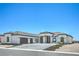 Stunning single-story home featuring a modern design, three-car garage, and beautiful desert landscaping at 1525 Heights Dr, Logandale, NV 89021