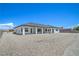 Rear exterior of a new construction house with a large backyard and covered patio at 1525 Heights Dr, Logandale, NV 89021