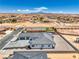 A sleek, modern home exterior with a gray roof and ample parking, set against a desert backdrop at 1525 Heights Dr, Logandale, NV 89021
