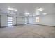 Spacious three car garage with white walls, concrete floors, and three garage doors at 1525 Heights Dr, Logandale, NV 89021