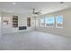 Open living room with built-in shelves, a modern fireplace, and large windows at 1525 Heights Dr, Logandale, NV 89021