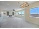 Open living room space featuring a modern light fixture, and large bright windows at 1525 Heights Dr, Logandale, NV 89021