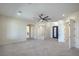 Spacious main bedroom with tile flooring, a ceiling fan, and multiple doors to other rooms at 1525 Heights Dr, Logandale, NV 89021