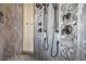 Custom tiled shower featuring wood-look large format tiles and a river rock accent wall with dual shower heads at 1525 Heights Dr, Logandale, NV 89021