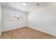 Bright bedroom with wood-look flooring and a window with blinds, creating a comfortable space at 1648 J St, Las Vegas, NV 89106