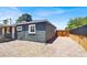 View of back of house with gated yard with covered air conditioning unit at 21 Laswell St, Henderson, NV 89015