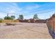 Spacious dirt back yard with gravel and mature trees at 21 Laswell St, Henderson, NV 89015
