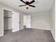 Empty bedroom featuring carpet, a ceiling fan, and 2 closets at 21 Laswell St, Henderson, NV 89015