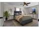 Staged bedroom featuring large bed, ceiling fan, and natural light at 21 Laswell St, Henderson, NV 89015