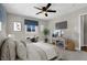 Staged bedroom with gray carpet, white trim, ceiling fan, and window at 21 Laswell St, Henderson, NV 89015