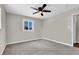 Neutral bedroom featuring gray carpet, white trim, ceiling fan and window at 21 Laswell St, Henderson, NV 89015