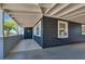 Covered patio offering protection from the elements is attached to the home's gray plank exterior at 21 Laswell St, Henderson, NV 89015